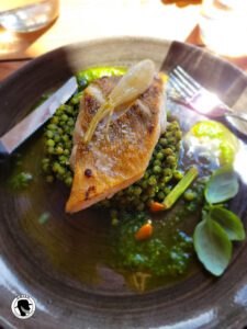 Image of cooked fish filet on a bead of spring peas