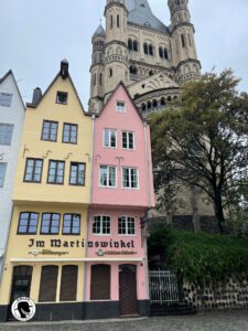 Image of colorful buildings of the Martinswinkel, with Gross St Martin on the hill in the background.