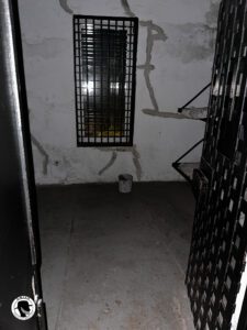 Image of a jail cell in the old city jail taken at night on the ghosts and gravestones tour