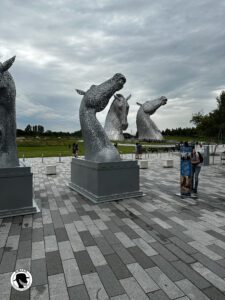 Image of the Kelpies in the background with a scale model in the foreground