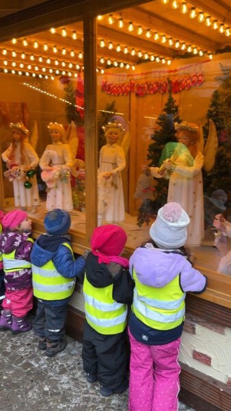 children watching an animatronic display of angels at the Kaiserhof Christmasvillage